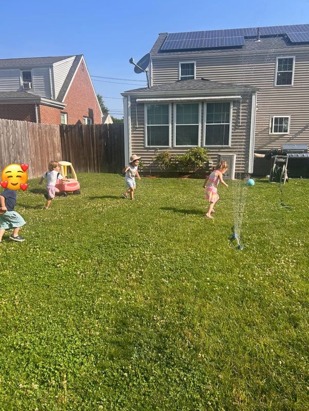 Children playing in the fenced backyard