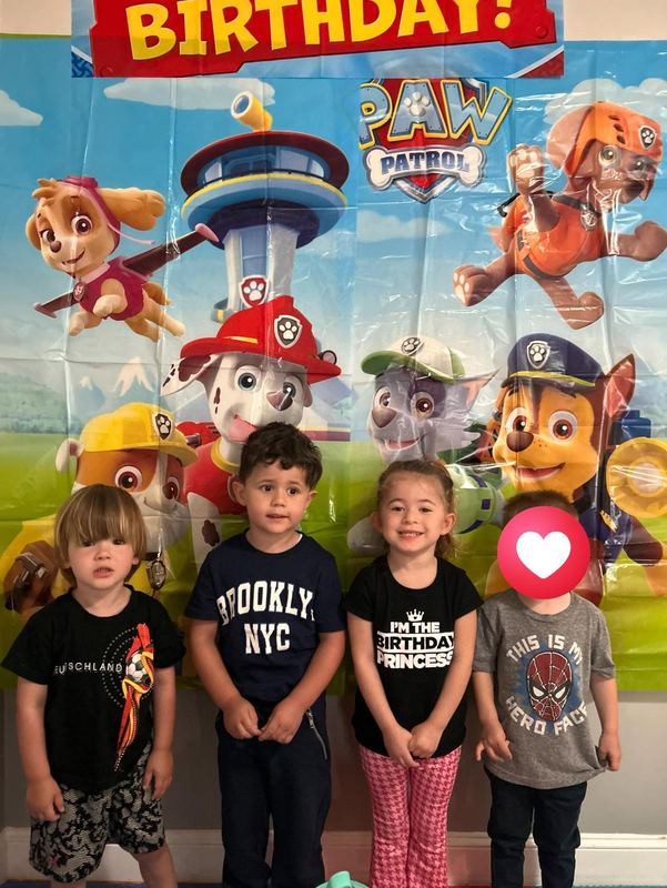 Four friends lined up at a birthday celebration