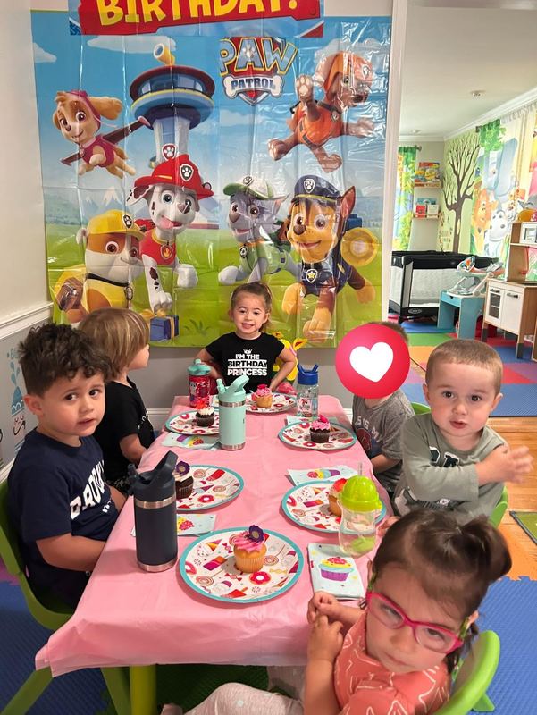 Children around a birthday party table