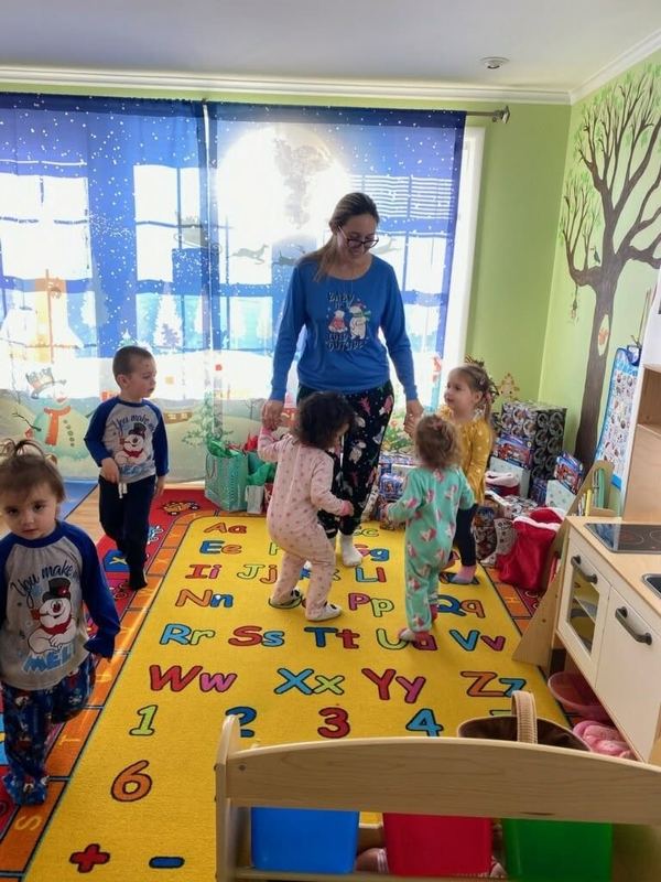 Children dancing on the alphabet rug