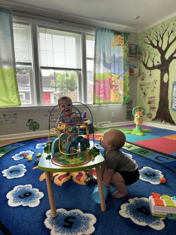 Babies exploring an activity center in the infant room