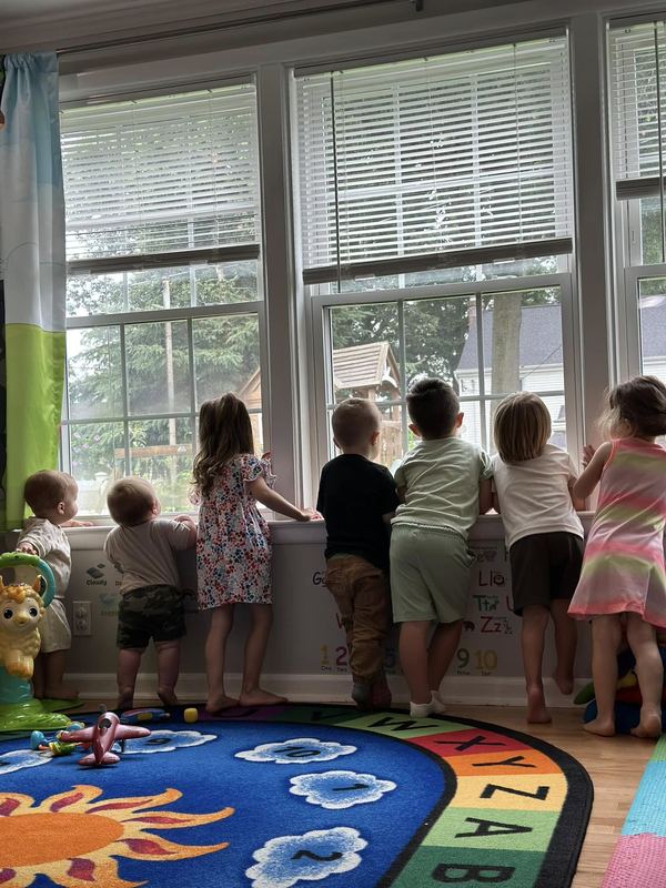 Children looking out the classroom windows together