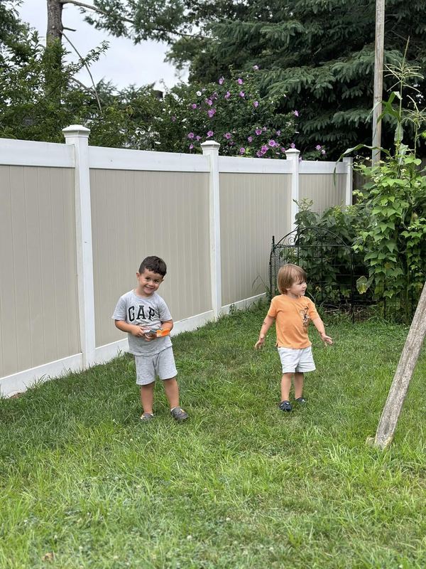 Two boys playing in the yard